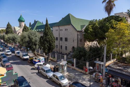 a city street with cars parked in front of a building at Numero 5 in Bari