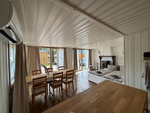 a kitchen and dining room with a table and chairs at Cozy 2-Bedroom Bungalow in Interlaken