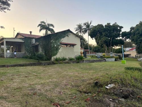 a house with a yard in front of it at Mussagy Guest House in Vila Praia Do Bilene