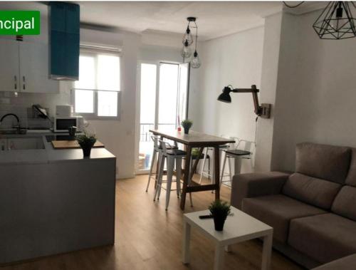 a living room with a couch and a table at APARTAMENTO en CENTRO HISTORICO in Murcia