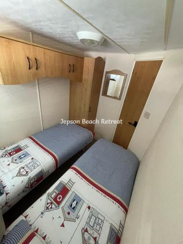 a small room with two beds in a small room at Mablethorpe Seaside - Jepson Beach Retreat in Mablethorpe