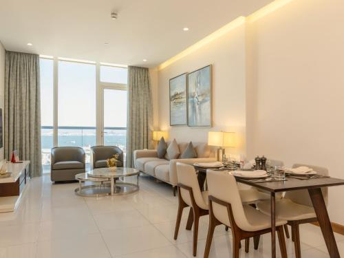 a living room with a couch and a table at Swiss-Belsuites Admiral Juffair in Manama