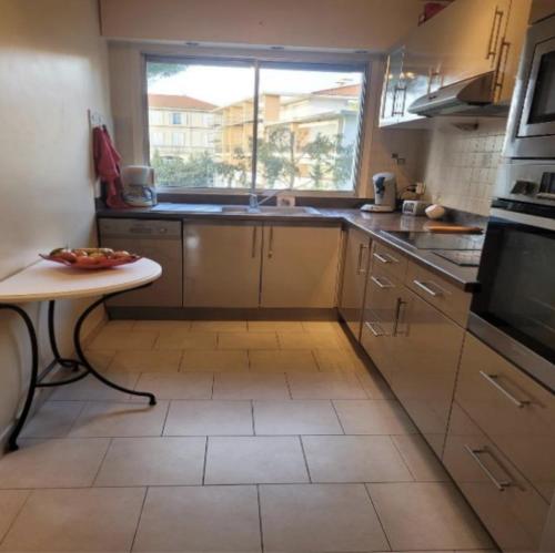 une cuisine avec un évier et une fenêtre dans l'établissement Center Cannes Montfleury, à Cannes