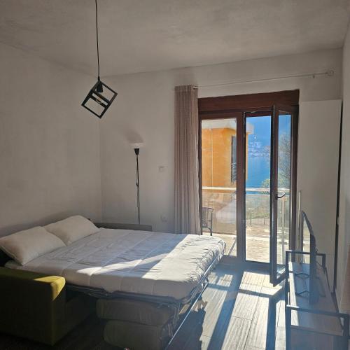 a bedroom with a bed and a sliding glass door at InesAna in Kotor