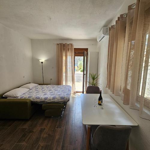 a bedroom with a bed and a table and a table sidx sidx sidx at InesAna in Kotor