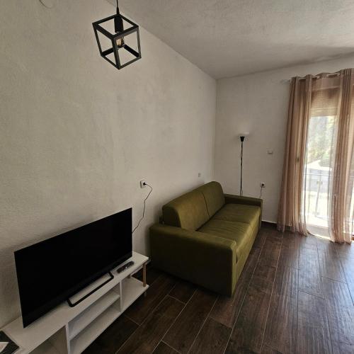 a living room with a couch and a flat screen tv at InesAna in Kotor