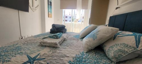 a large bed with pillows on top of it at Canela Tenerife Apartment in Puertito de Güímar