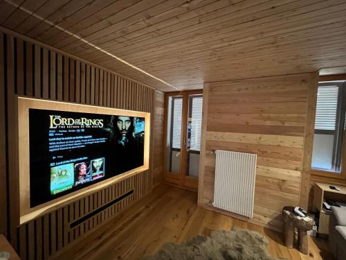 a living room with a large flat screen tv on a wall at Evolène Panorama- Renovated Apartment with Dent Blanche View 2-4 persons in Evolène