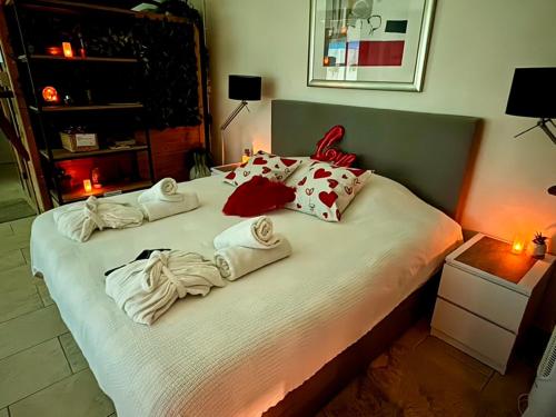 a bedroom with a bed with towels on it at B&B Wellness Soest in Soest