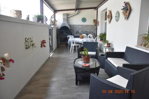 a living room with couches and a table and a dining room at Casa Vacanze Giorgia in Marinella di Selinunte