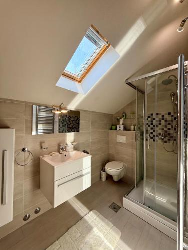 a bathroom with a sink toilet and a skylight at House Bianca Brac - New Listing - Experienced host in Postira