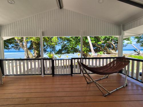 a hammock on a porch with a view of the ocean at Majuro Beachfront Container Home in Majuro