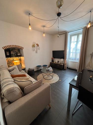 a living room with a couch and a table at Appartement F3 hyper centre in Ajaccio