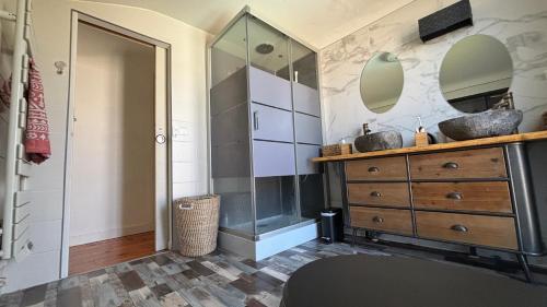 La salle de bains est pourvue d'une commode en bois et d'une douche en verre. dans l'établissement Villa TIKI BAR piscine chauffée 4 chambres, à Labenne