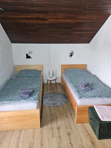 una habitación con dos camas y una mesa en Holiday Home NA VASI, en Gorenja Vas