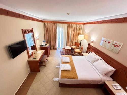 a hotel room with a bed and a living room at Romance Regency Club in Sharm El Sheikh