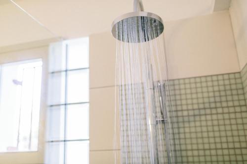 a shower in a bathroom with a glass wall at Villa Melivia in Hersonissos