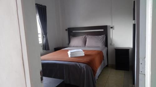 a bedroom with a bed with two towels on it at Hotel Arda Bali in Negara