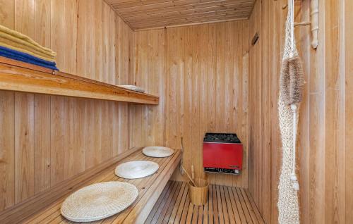 a sauna with two toilets in a wooden room at Cozy Home In Nørre Nebel With Sauna in Nørre Nebel