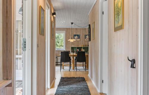 a hallway leading to a dining room with a table at Cozy Home In Nørre Nebel With Sauna in Nørre Nebel