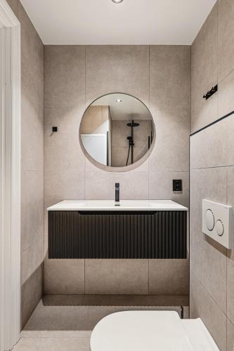 a bathroom with a sink and a mirror at Odda Living - 3BR & 1BR - A3 in Tokheim