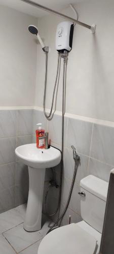 a bathroom with a shower and a sink and a toilet at Adam&Eva Condo Staycation in Lapu Lapu City
