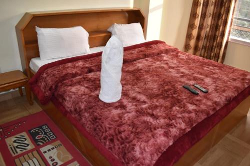 Ένα ή περισσότερα κρεβάτια σε δωμάτιο στο AbhiAak Regency Homestay