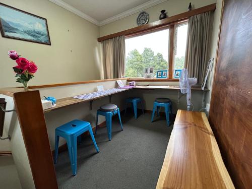 a waiting room with a desk and stools at Rest & Relax Units in Whangarei