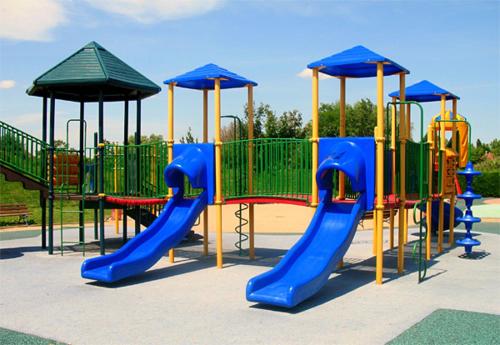a playground with a blue and red slide at Hotel OUM EL FADL in Fkih Ben Salah