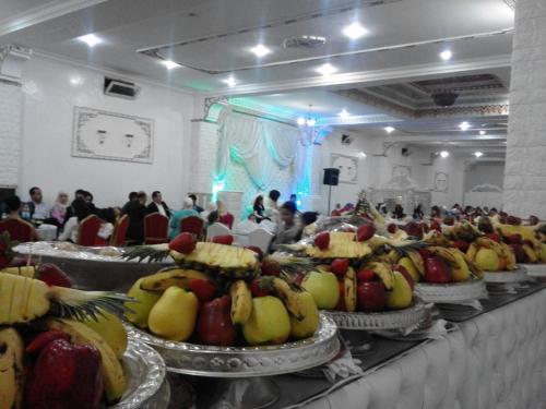 a buffet line with bananas and other fruit on plates at Hotel OUM EL FADL in Fkih Ben Salah