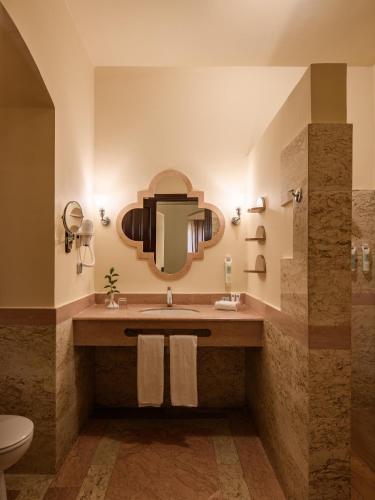 a bathroom with a sink and a mirror at Iberotel Redsina in Sharm El Sheikh