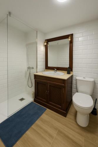 a bathroom with a toilet and a sink and a mirror at Casa Kiona in Moratalla