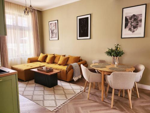 een woonkamer met een bank en een tafel bij Olive Apartment 1 - w Free Parking, self-checkin, 5 min from Aquapark Nymphaea in Oradea