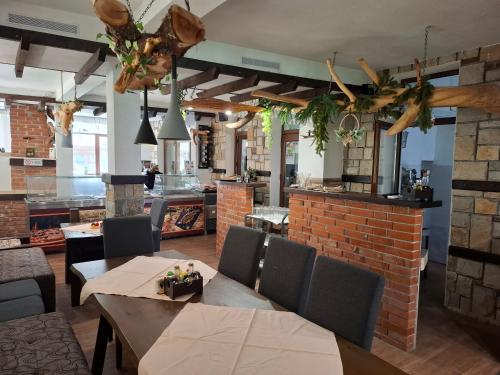 a restaurant with tables and chairs and a brick wall at Horlog Castle in Trigrad