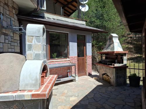 a outdoor grill with a bench next to a house at Horlog Castle in Trigrad