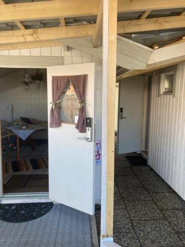 a door in a house with a room with a table at Mysigt och Centralt in Strömstad