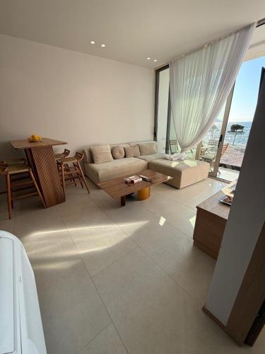 a living room with a couch and a table at Solea Apartment in Vlorë