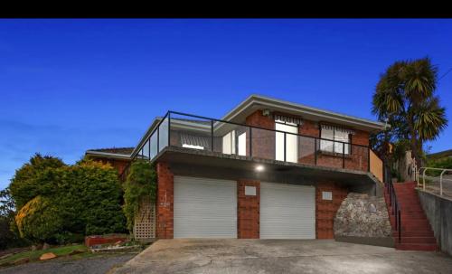 a large brick house with a garage at Natural & Relax House in West Ulverstone in Ulverstone