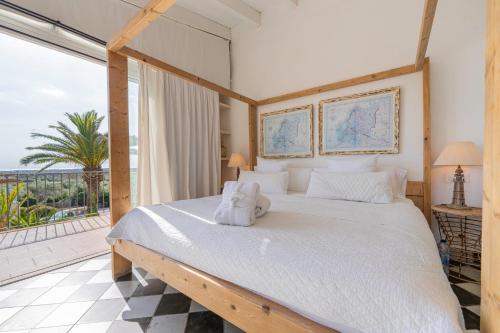 a bedroom with a large bed and a balcony at Finca Hotel Rural Es Turó in Ses Salines