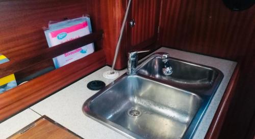 a kitchen counter with a sink in a vehicle at Veludstyret båd, med indbygget varme og gratis Wifi in Fåborg