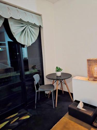 a table and chair in a room with a window at Angkor Legacy Boutique in Siem Reap