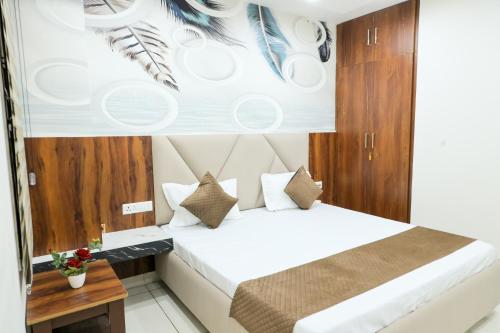 a hotel room with a bed and a table at Mand Canal View Rest House FOR FAMILIES ONLY in Jalandhar