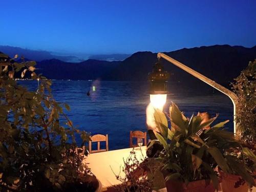 a light on a table next to a body of water at Casa Pantagana in Kotor