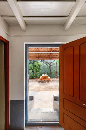 a sliding glass door in a room with a view at Underground Hostel By Bilwa Estate in Madikeri