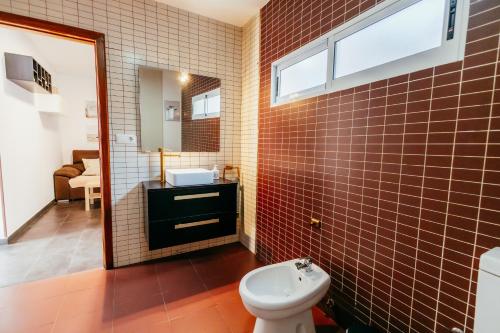 a bathroom with a toilet and a sink and a mirror at Casa Pancho, ChillOut, Oceanographic, City of Arts in Valencia