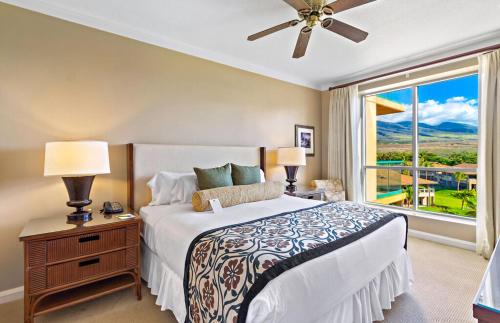a bedroom with a bed and a large window at Honua Kai Resort And Spa By Maui Resort Rentals in Lahaina