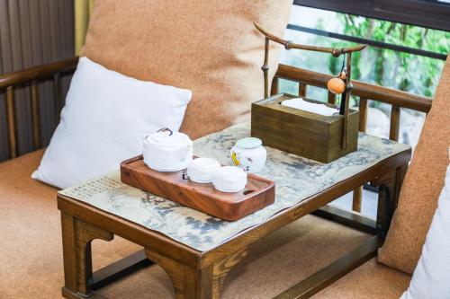 a table with a tray with cups and a box on it at 南京又见江南民宿 in Nanjing