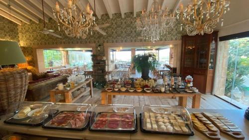 a buffet with several trays of food on a table at Finca Hotel Rural Es Turó in Ses Salines