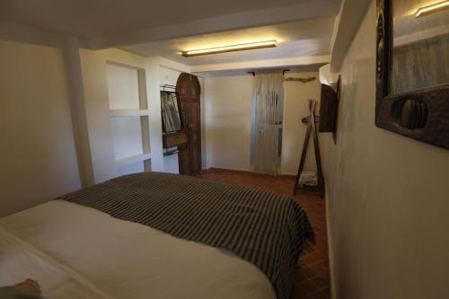 a bedroom with a bed in a room at DAR MUKTAB in Chefchaouene