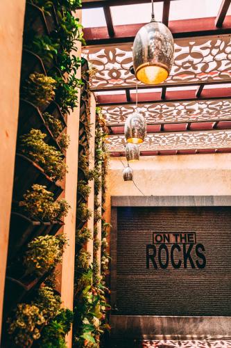 a sign that says on the rocks on a building at Hotel Rock Fort View in Tiruchchirāppalli